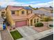 View of lovely two-story home with solar panels, desert landscaping, two-car garage, and quaint porch at 7129 Dillseed Dr, Las Vegas, NV 89131