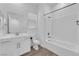 Bright bathroom with white cabinets, a large mirror, and a shower over the tub at 720 Webber Park St, Henderson, NV 89011