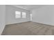 Spacious carpeted bedroom with a doorway to the outside and bright windows at 720 Webber Park St, Henderson, NV 89011