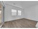 Empty bedroom with wood floors, natural light, and two large windows at 720 Webber Park St, Henderson, NV 89011