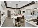 Bright kitchen with white cabinetry, modern appliances, central island with seating, and tiled flooring and backsplash at 720 Webber Park St, Henderson, NV 89011