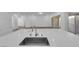 Kitchen island featuring a sink and views of the living area and backyard at 720 Webber Park St, Henderson, NV 89011