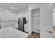 Bright kitchen with stainless steel refrigerator, pantry and modern white cabinets at 720 Webber Park St, Henderson, NV 89011