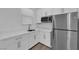 Modern kitchen features stainless steel appliances, white countertops, and ample cabinet space at 720 Webber Park St, Henderson, NV 89011