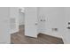 Bright laundry room with white walls, wood-style flooring, and utility connections at 720 Webber Park St, Henderson, NV 89011