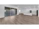 Bright living room with wood floors, sliding glass doors, and modern kitchen at 720 Webber Park St, Henderson, NV 89011