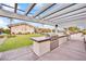 Outdoor kitchen with built-in grills and ample countertop space perfect for entertaining at 720 Webber Park St, Henderson, NV 89011
