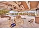 Inviting poolside seating area with comfortable chairs and tables under a shaded pergola at 720 Webber Park St, Henderson, NV 89011