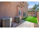 Backyard featuring artificial grass, stamped concrete, and side yard access at 7641 Lani Dawn St, Las Vegas, NV 89149