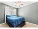 Simply decorated bedroom featuring a comfortable bed with modern bedding and a ceiling fan at 7641 Lani Dawn St, Las Vegas, NV 89149