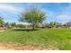 Expansive community park with vibrant green grass, mature trees, and walking paths for recreational activities at 7641 Lani Dawn St, Las Vegas, NV 89149