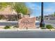 A stone sign for Terrasano community sits at the entrance with attractive landscaping on a sunny day at 7641 Lani Dawn St, Las Vegas, NV 89149