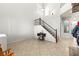 Bright entryway with soaring ceilings, staircase with iron railing, and tile flooring at 7641 Lani Dawn St, Las Vegas, NV 89149