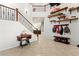 Bright foyer boasts staircase with wrought iron railing and decorative floating shelves at 7641 Lani Dawn St, Las Vegas, NV 89149