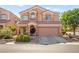 Two-story home with a well-manicured lawn, covered porch, and a two-car garage at 7641 Lani Dawn St, Las Vegas, NV 89149