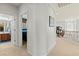 Upstairs hallway leading to a bedroom and bathroom featuring modern lighting and neutral decor at 7641 Lani Dawn St, Las Vegas, NV 89149