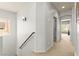 Upstairs hallway with carpeted flooring and neutral paint, leading to multiple rooms at 7641 Lani Dawn St, Las Vegas, NV 89149