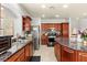 Well-lit kitchen features stainless appliances, tile floors and beautiful granite countertops at 7641 Lani Dawn St, Las Vegas, NV 89149