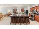 Spacious kitchen island with seating, tile floors, stainless appliances and granite countertops at 7641 Lani Dawn St, Las Vegas, NV 89149
