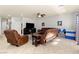 Comfortable living room offers tile floors, neutral walls, ceiling fan, and ample seating at 7641 Lani Dawn St, Las Vegas, NV 89149