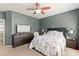 Cozy main bedroom featuring a ceiling fan, dresser, and a comfortable bed with floral bedding at 7641 Lani Dawn St, Las Vegas, NV 89149