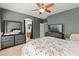 Comfortable main bedroom with a ceiling fan, dresser, and a floral bed set, offering a relaxing space at 7641 Lani Dawn St, Las Vegas, NV 89149
