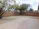 Spacious backyard with neutral desert landscaping and a small patio at 7924 Pale Rider St, Las Vegas, NV 89131