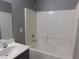 Modern bathroom featuring a single sink, vanity with modern hardware, and shower-tub combination at 7924 Pale Rider St, Las Vegas, NV 89131