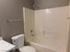 Bathroom boasts a shower-tub combination, tiled walls, and vanity at 7924 Pale Rider St, Las Vegas, NV 89131