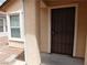 Inviting entryway featuring a secure screen door, painted stucco, and a nearby window at 7924 Pale Rider St, Las Vegas, NV 89131