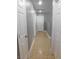 Hallway featuring neutral walls and flooring, white trim and doors, and overhead lighting at 7924 Pale Rider St, Las Vegas, NV 89131