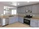 Kitchen with gray cabinets, granite countertop, and stainless steel appliances at 7924 Pale Rider St, Las Vegas, NV 89131