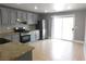 Modern kitchen featuring stainless steel appliances, granite countertops, and tile flooring at 7924 Pale Rider St, Las Vegas, NV 89131
