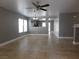 Spacious living room with neutral gray walls, tile flooring, and a ceiling fan at 7924 Pale Rider St, Las Vegas, NV 89131
