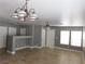 Neutral living area with tile flooring, updated lighting, and gray walls at 7924 Pale Rider St, Las Vegas, NV 89131