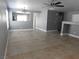 Open-concept living room features neutral gray walls, tile flooring, and recessed lighting at 7924 Pale Rider St, Las Vegas, NV 89131