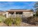 Backyard showcasing desert landscaping, a covered patio and solar panels on the roof at 7927 Crested Starling Ct, North Las Vegas, NV 89084
