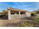 Backyard featuring desert landscaping, a covered patio and solar panels on the roof at 7927 Crested Starling Ct, North Las Vegas, NV 89084