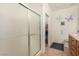 Bright bathroom features a glass shower, a commode, a closet, and a sink with granite countertops at 7927 Crested Starling Ct, North Las Vegas, NV 89084
