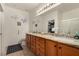 Bathroom with double sinks, granite counters, and a walk-in closet with a glass shower door at 7927 Crested Starling Ct, North Las Vegas, NV 89084