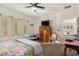 Bright bedroom features a ceiling fan, and an ensuite bath with an open doorway and lots of natural light at 7927 Crested Starling Ct, North Las Vegas, NV 89084
