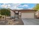 Charming home featuring desert landscaping, a two-car garage, and quaint seating near the front door at 7927 Crested Starling Ct, North Las Vegas, NV 89084