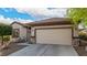 Inviting single-story home featuring desert landscaping and a two-car garage with stone accents at 7927 Crested Starling Ct, North Las Vegas, NV 89084