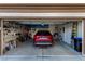 Spacious garage featuring organized storage solutions and a red SUV parked inside at 7927 Crested Starling Ct, North Las Vegas, NV 89084