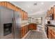 Bright eat-in kitchen with stainless appliances and granite countertops, opening to the backyard through glass sliding doors at 7927 Crested Starling Ct, North Las Vegas, NV 89084
