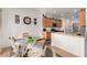 Eat-in kitchen features updated cabinets and stainless steel appliances, with an island and sink overlooking the dining area at 7927 Crested Starling Ct, North Las Vegas, NV 89084