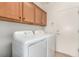 Functional laundry room with washer, dryer, and ample cabinet space for storage at 7927 Crested Starling Ct, North Las Vegas, NV 89084