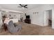 Comfortable living room featuring plush carpeting, a ceiling fan, and seamless transitions to other areas at 7927 Crested Starling Ct, North Las Vegas, NV 89084