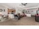 Expansive living room with a view into the kitchen, plush carpeting, and comfortable seating at 7927 Crested Starling Ct, North Las Vegas, NV 89084