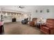 Spacious living room with plush carpeting and abundant natural light from a wide window at 7927 Crested Starling Ct, North Las Vegas, NV 89084